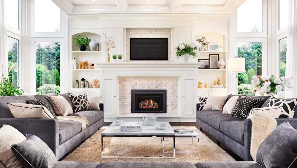 Spacious living room with large windows, modern decor, and a cozy fireplace.