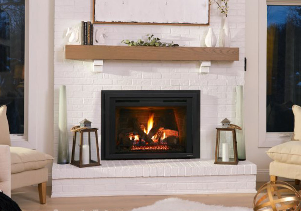 Cozy living room with a modern fireplace, white brick surround, and wooden mantel, featuring decorative lanterns and vases.
