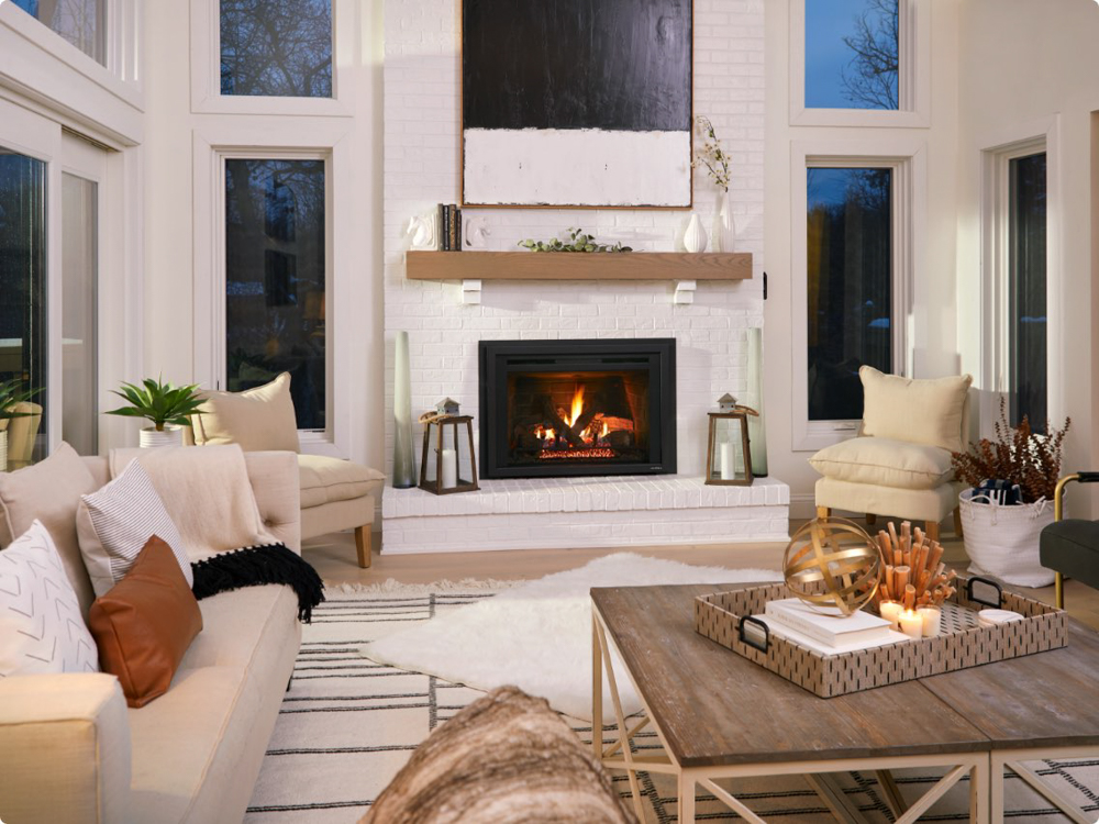 Cozy living room with a modern fireplace, beige sofas, and decorative accents.